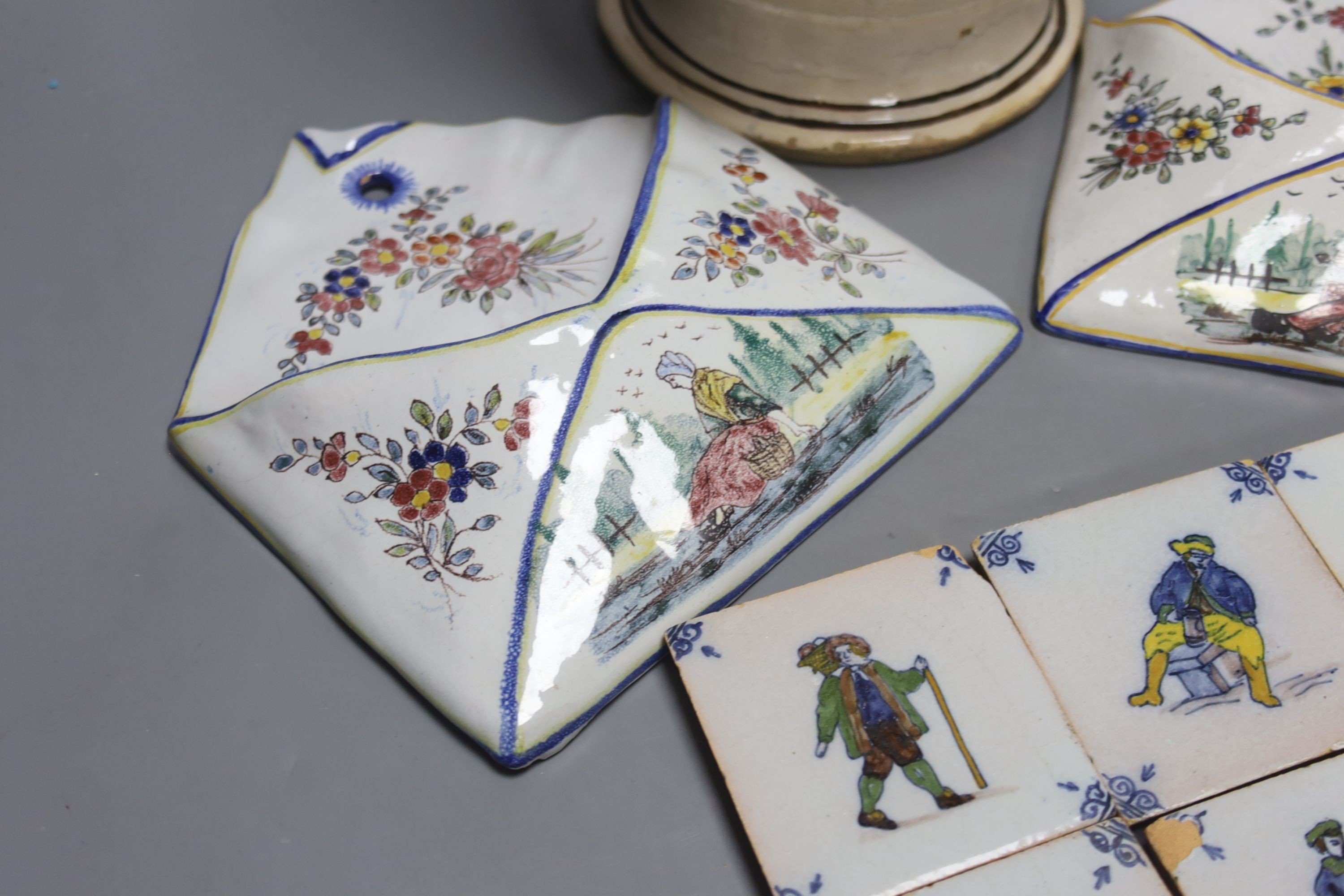 A pair of Delft wall brackets, a set of six delft small tiles and a large maiolica pitcher, height 30cm